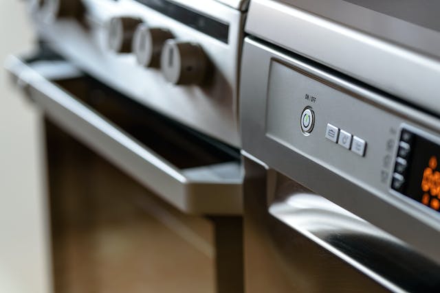 A closeup of the buttons on an oven.