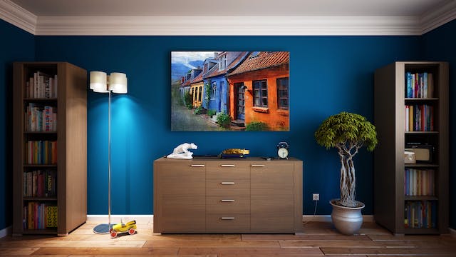 A bedroom dresser with a large painting above it