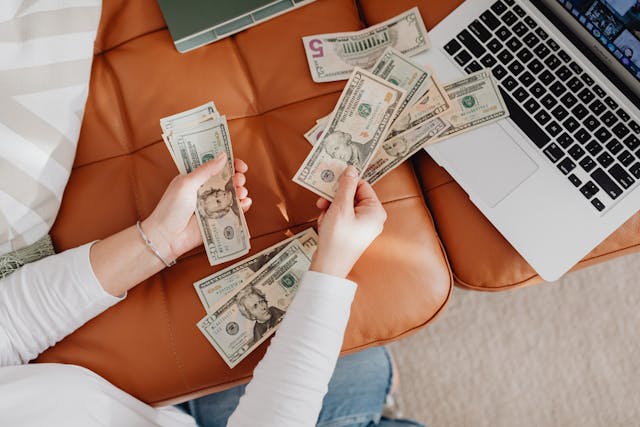 counting-cash-on-orange-couch