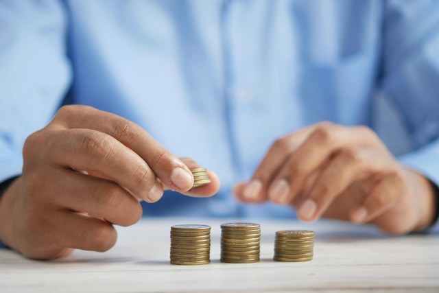 Hands stacking coins.