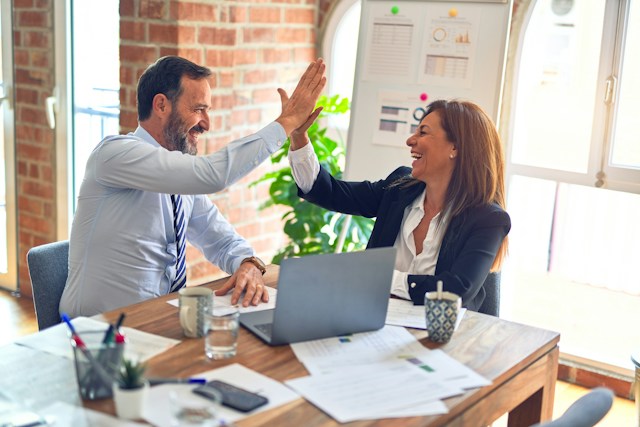 Two businesspeople high-fiving