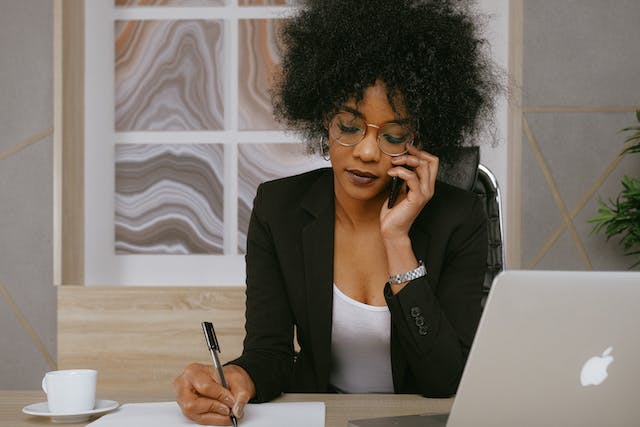 A landlord on a phone call and taking notes.