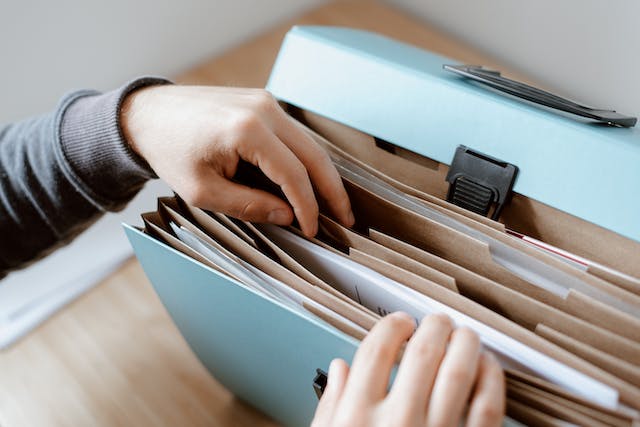 A pair of hands sifting through some files