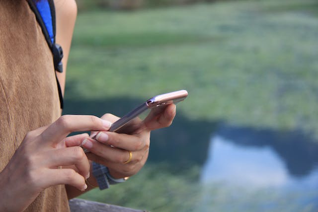 The hands of a person texting on an iPhone